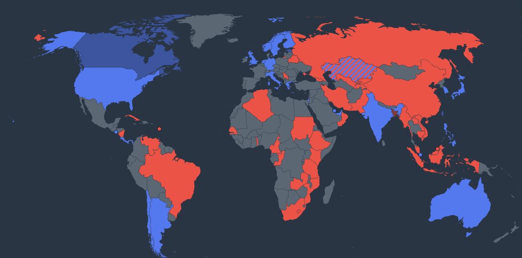 A world map with countries coloured blue or red according to the bloc they joined, unaligned countries in grey, and one country striped in both colours
